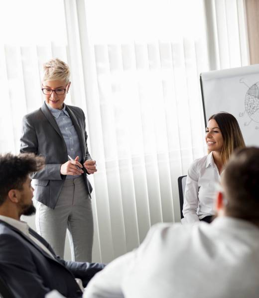 Business team on a morning briefing; business meeting and presentation in a modern office. Focus on the women