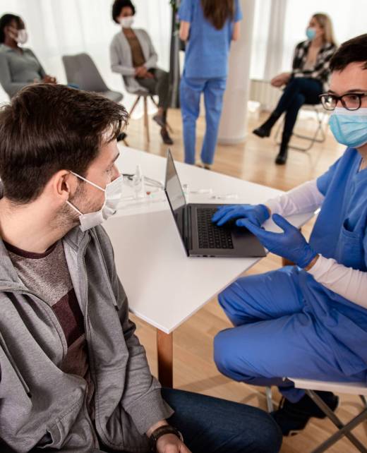Patient fills out the forms before receiving vaccine in clinic.